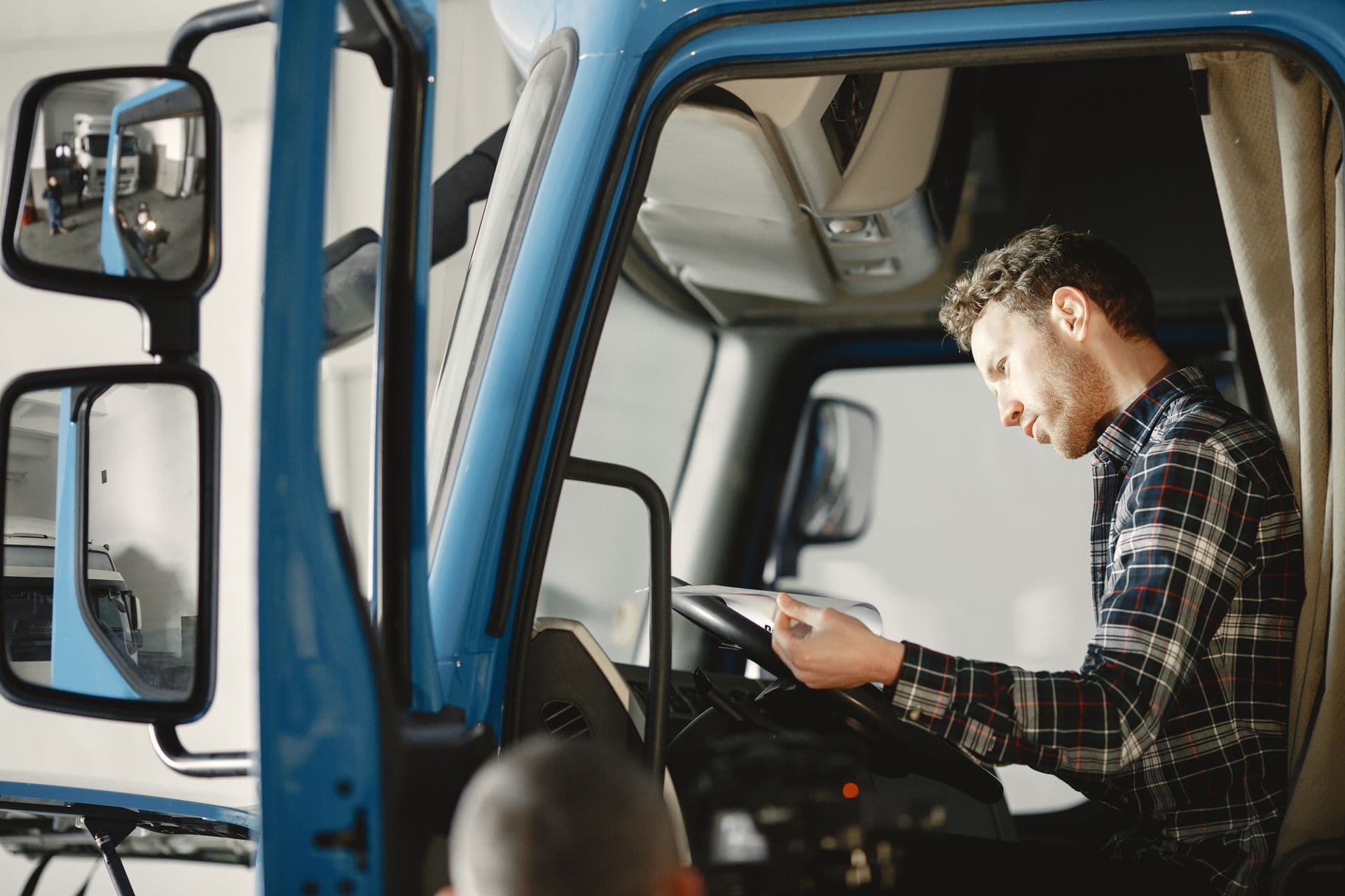 Driver reading documents inside a truck cab