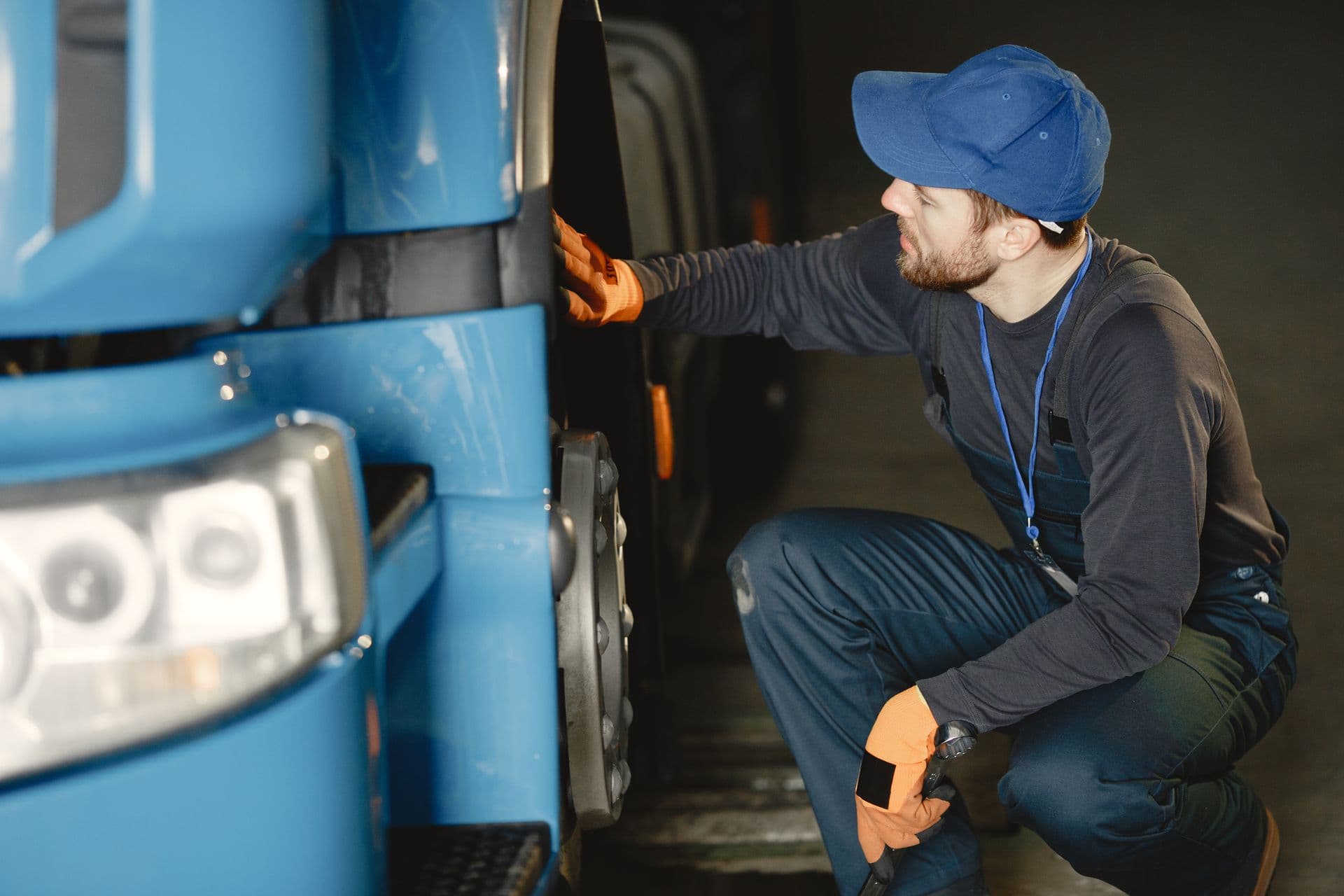 Worker inspecting a truck wheel